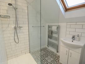 A bathroom with a shower and sink at Treestumps in Benllech