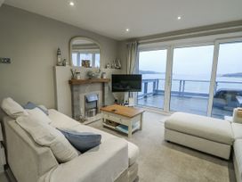 A living room with a sofa and television at White Sails Y Felinheli