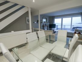 A dining room with glass table and chairs at White Sails Y Felinheli