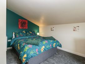 A bedroom with a bed and decorative items at Top Lodge Llanvair-Discoed near Penhow