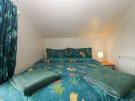 A bedroom with a bed and lamp at Top Lodge in Llanvair-Discoed near Penhow
