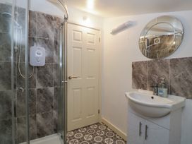 A bathroom with a shower and sink at Top Lodge Llanvair-Discoed near Penhow
