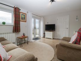 A living room with a TV and sofa at Top Lodge in Llanvair-Discoed near Penhow