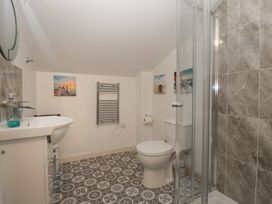 A bathroom with shower, toilet, and washbasin at Top Lodge in Llanvair-Discoed near Penhow