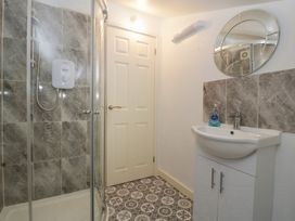 A bathroom with a shower and sink at Top Lodge in Llanvair-Discoed near Penhow