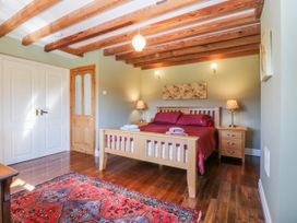 A bedroom with a bed and nightstands at Bronfa in Tregarth
