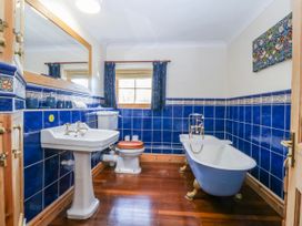 A bathroom with a bathtub and sink at Bronfa in Tregarth