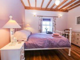 A bedroom with a bed and nightstand at Bronfa in Tregarth