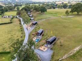 An aerial view of cabins and a gravel road at The Salmon in Nantmel near Rhayader