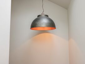 A lamp hanging from the ceiling at Cringol Cottage Ambleside