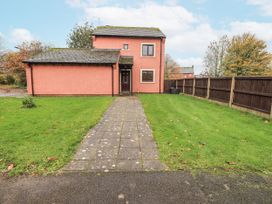 A house with a pathway and grass yard at 1 Eamont Park in Penrith