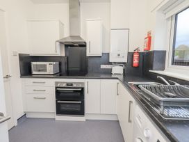 A kitchen with appliances and cabinets at 1 Eamont Park Penrith