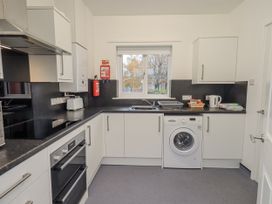 A kitchen with appliances and cupboards at 1 Eamont Park in Penrith