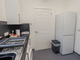 A kitchen with a fridge and sink at 1 Eamont Park Penrith