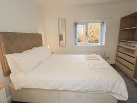 A bedroom with a bed and dresser at 1 Eamont Park in Penrith