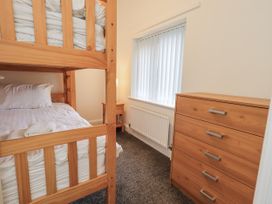A bedroom with bunk bed and chest of drawers at 1 Eamont Park in Penrith