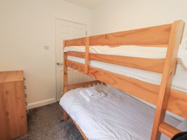 A bedroom with a bunk bed and a chest of drawers at 1 Eamont Park in Penrith