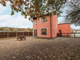 A house with a picnic table and trees at 1 Eamont Park Penrith