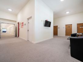 A hallway with doors and a television at Jubilee Three Bedroom House Pet Free Penrith