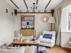 A living room with a sofa and coffee table at 7 Duporth Bay in St. Austell