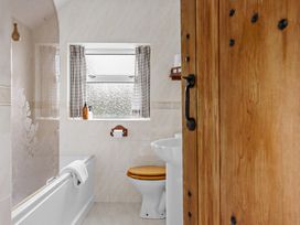A bathroom with a bathtub and a sink at 7 Duporth Bay in St. Austell