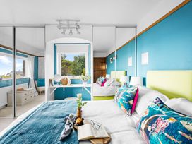 A bedroom with two beds and a window at 7 Duporth Bay in St. Austell