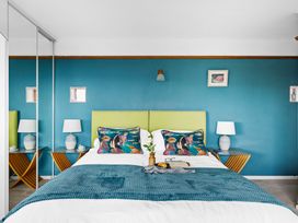 A bedroom with a bed and bedside tables at 7 Duporth Bay in St. Austell