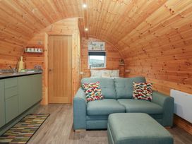 A living room with a sofa and kitchen cabinet at Beech in Ulverston