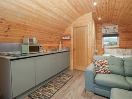 A kitchen with cabinetry and a sofa at Beech in Ulverston