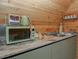 A kitchen with a toaster, kettle, microwave, and croissant at Beech in Ulverston