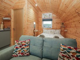 A bedroom with a bed and sofa at Beech in Ulverston