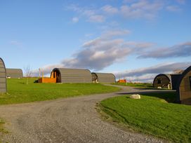 Various pods on a grassy area with a pathway at Beech in Ulverston