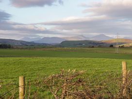 A landscape with grass fields and distant hills at Beech in Ulverston