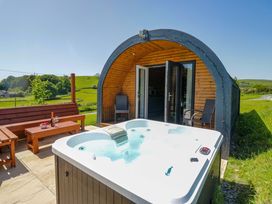 An outdoor area with a hot tub and seating at Beech in Ulverston
