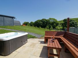 An outdoor area with a hot tub and seating at Beech in Ulverston