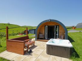 An outdoor area with a hot tub and seating at Beech in Ulverston