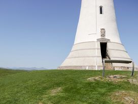 A tower with steps in a grassy landscape at Beech in Ulverston
