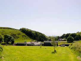 A view of buildings and trees in a grassy landscape at Beech in Ulverston