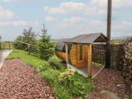 A shepherd's hut in a garden at The Herdsman Luxury Shepherds Hut in Barnoldswick