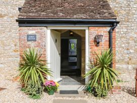 An entrance with plants and a sign at Abbey Grange near Charmouth