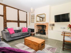 A living room with a fireplace and sofa at The Abbey Grange near Charmouth