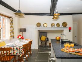 A kitchen with a dining table and chairs at The Abbey Grange near Charmouth