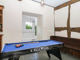 A game room with a pool table and door at The Abbey Grange near Charmouth