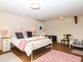A bedroom with a bed and side table at The Abbey Grange near Charmouth