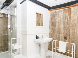 A bathroom featuring a sink and shower at The Abbey Grange near Charmouth