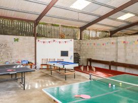 A recreation room with ping pong tables and table football at The Abbey Grange near Charmouth