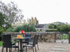 A table with drinks and chairs in a garden at The Abbey Grange near Charmouth