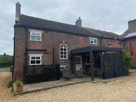 A house with a patio and seating area at The Hollies Thurstonfield near Carlisle