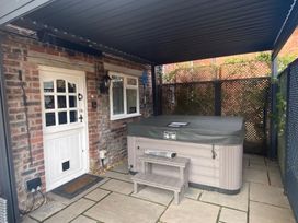 An outdoor area with a hot tub and door at The Hollies Thurstonfield near Carlisle