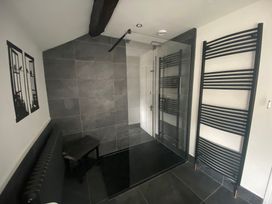A bathroom with a shower and radiator at The Hollies in Thurstonfield near Carlisle